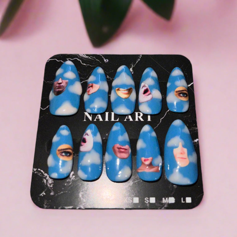 Set of blue nail art designs on a black card with a pink background