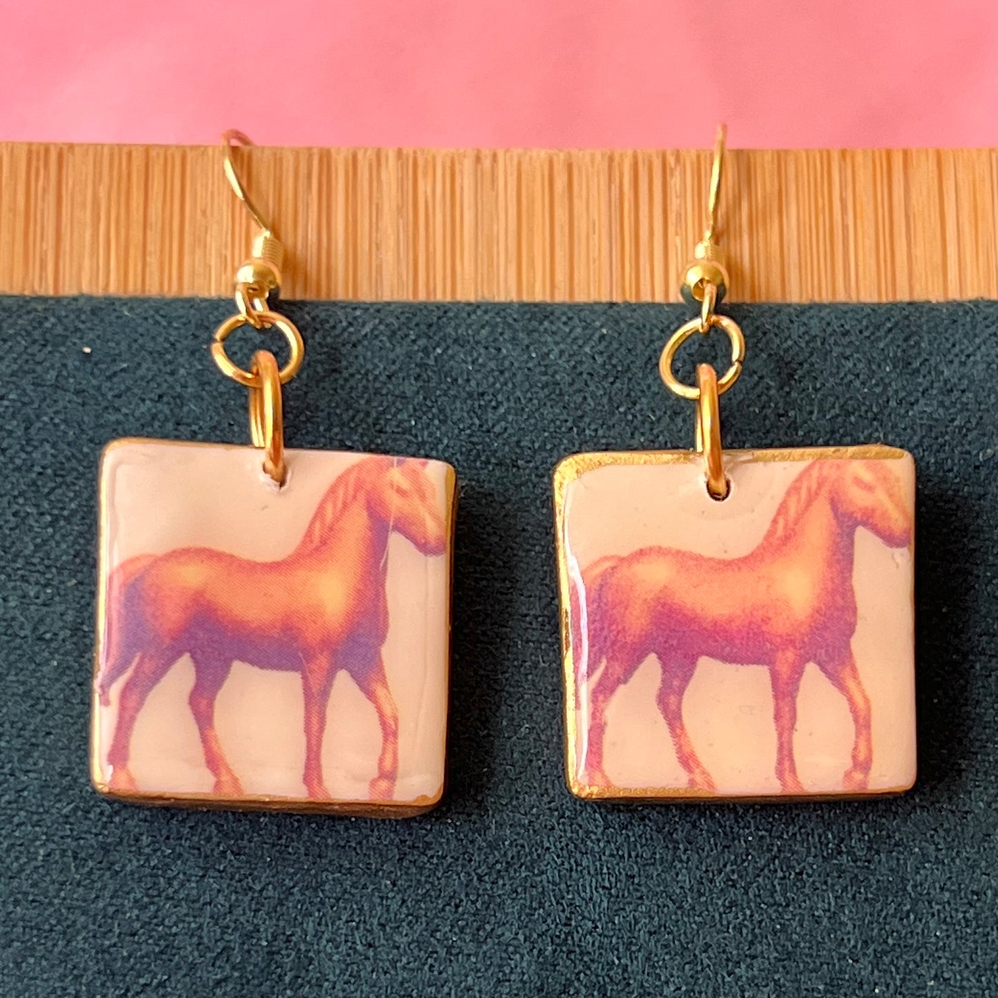 Handmade golden toy horse earrings with polymer‑clay mini horse charms painted in metallic gold, featuring gold‑plated hypoallergenic hooks—dreamcore, trinketcore, nostalgic jewelry perfect for collectors.