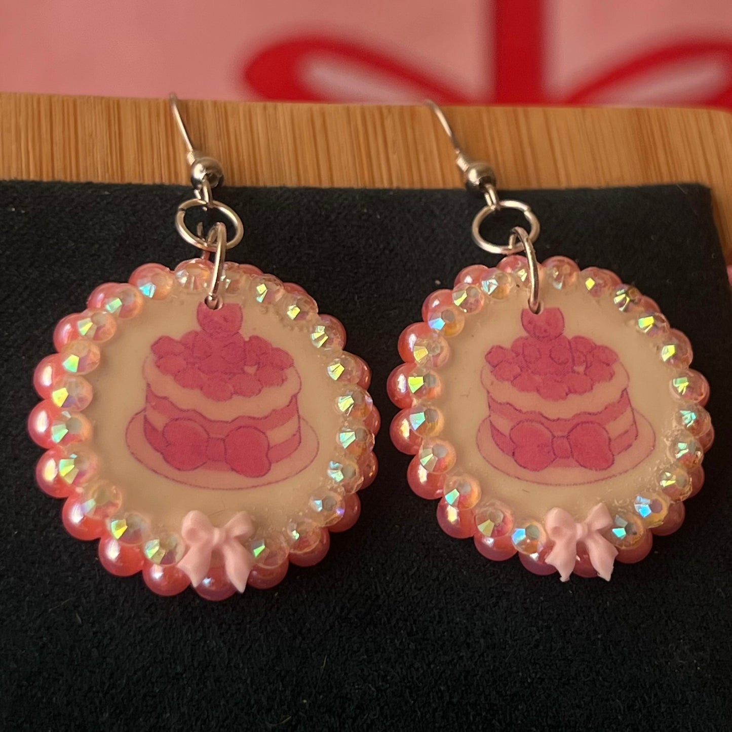 Alt text: Handcrafted polymer‑clay jelly cake earrings with pink coquette bows, iridescent pearls and rhinestones – a sweet, pastel kawaii accessory perfect for a cute dangle look.