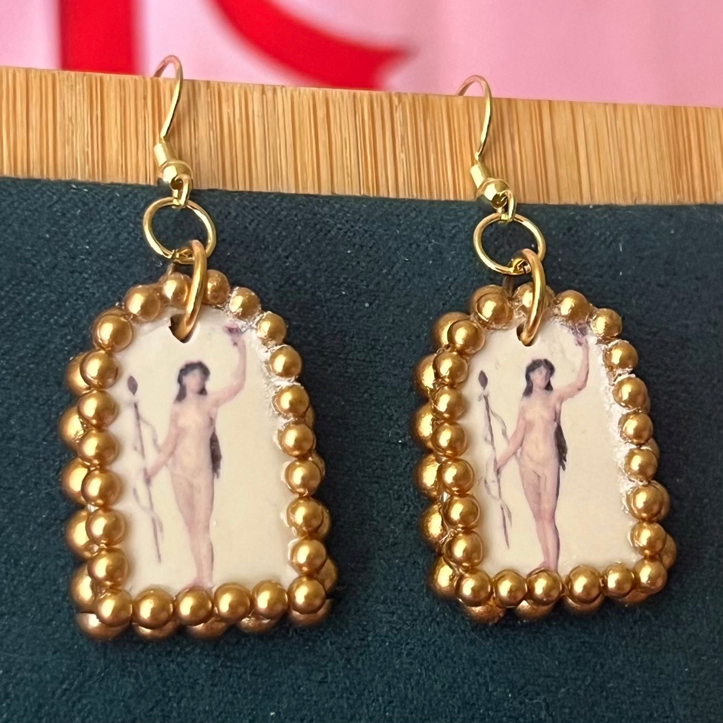 Handmade nude lady earrings featuring bronze polymer‑clay arch charms with an oil‑painting‑style image transfer and a sparkling pearl frame, set on 18k gold‑plated, hypoallergenic findings—perfect museum‑core, renaissance, medieval, coquette, and fairycore jewelry.