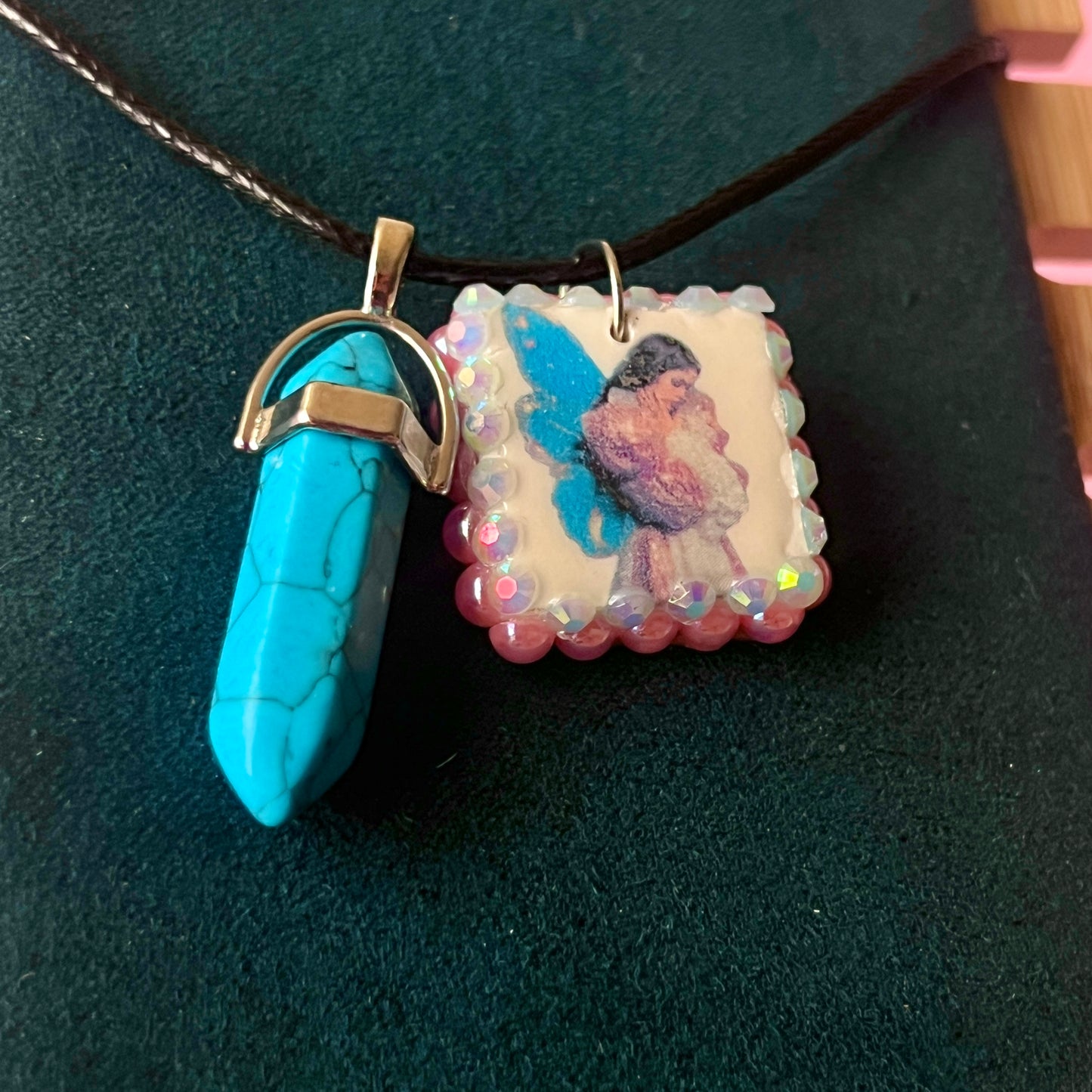 Pink + blue fairy charm necklace — handmade polymer clay fairy pendant framed with iridescent pearls, finished with bright blue gem drop on 22" vegan leather chain with 1.5" extender for adjustable fit. Soft fairycore talisman jewelry. Ready to ship.
