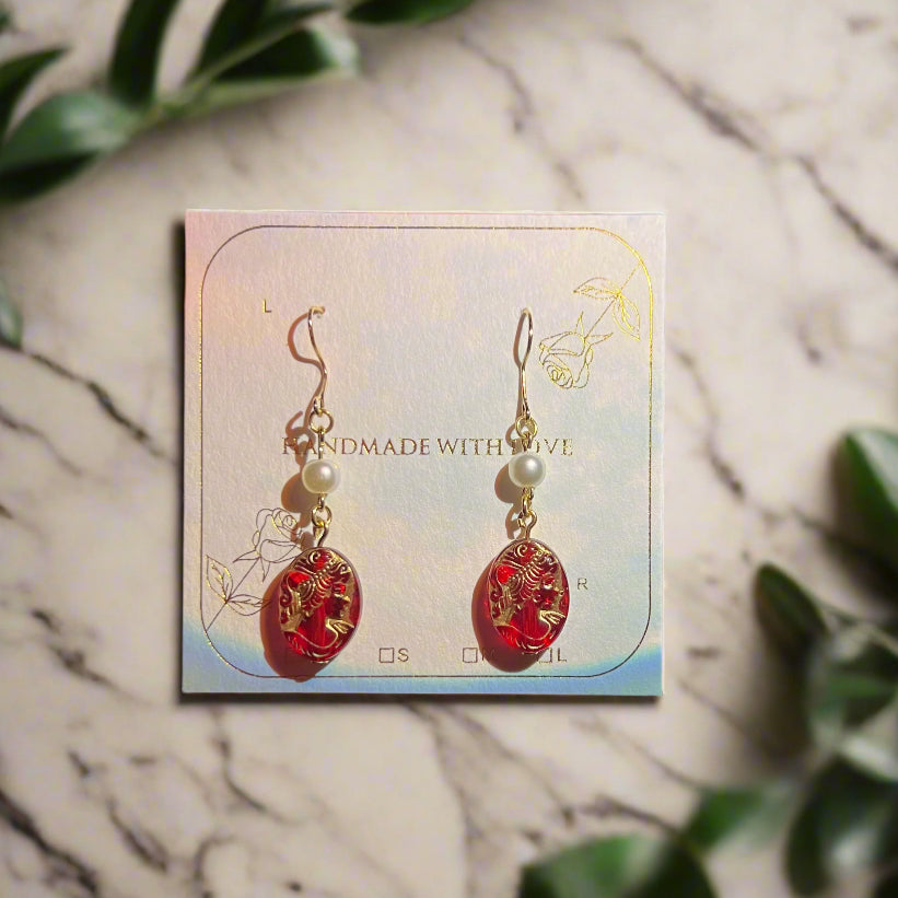 Product packaging with earrings on a dark background