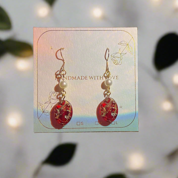 Card with earrings on a reflective surface