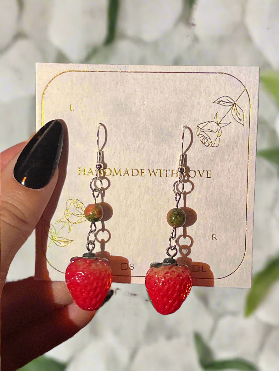 Strawberry-shaped earrings on a 'Handmade with Love' card.