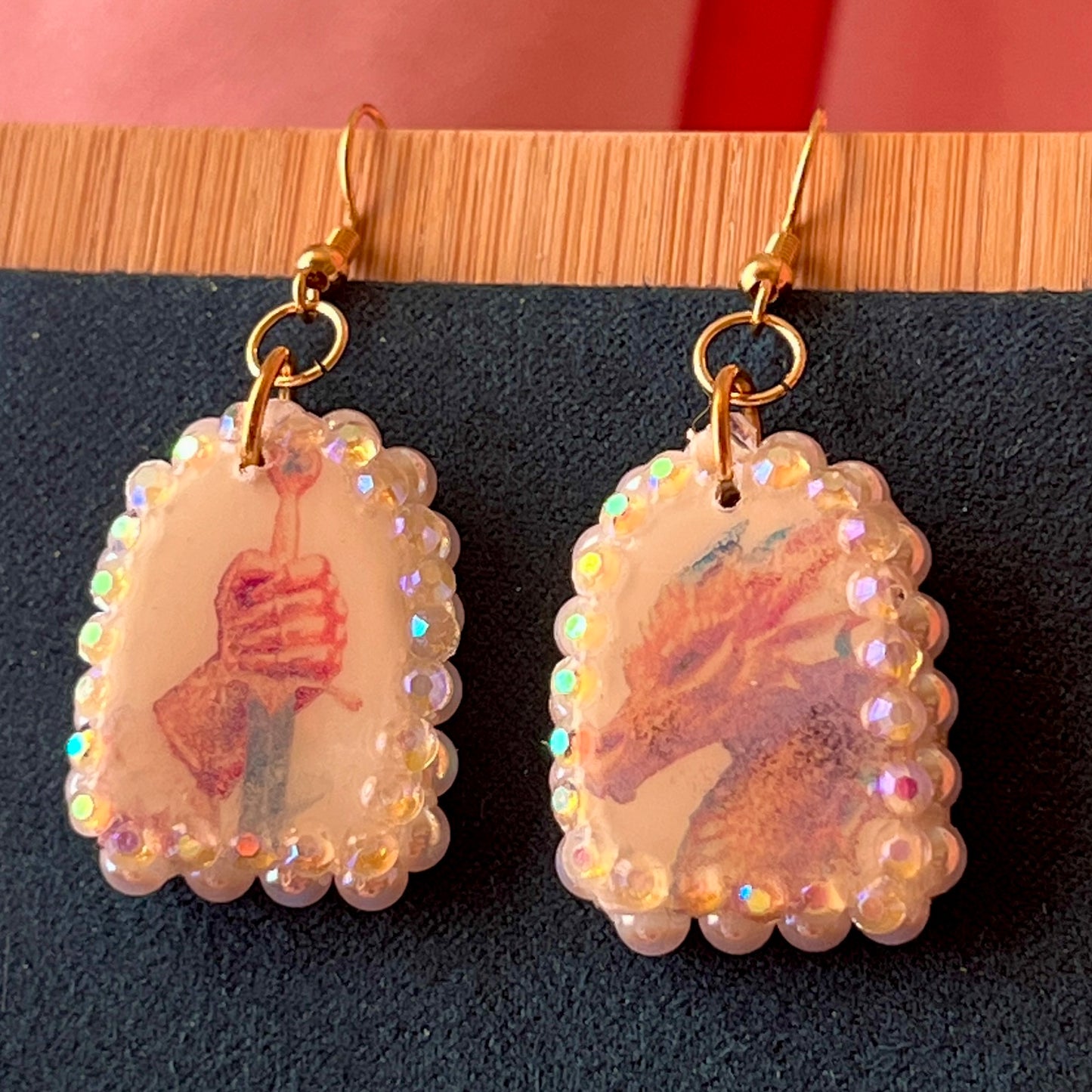 Handcrafted polymer‑clay earrings featuring a peace‑making knight and dragon motif, embellished with iridescent pearl beads, rhinestones, and 18k gold‑plated hypoallergenic findings—perfect whimsical, fairy‑core, fantasy jewelry.