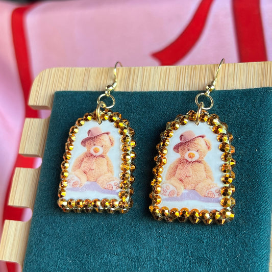 teddy bear earrings, bear earrings, teddy in hat earrings, kawaii earrings, kidcore earrings, indie earrings, party earrings, plushie earrings, polymer clay earrings, handmade earrings, clay statement earrings, orange rhinestone earrings, 14k gold plated earrings, cute animal earrings, novelty earrings, maximalist earrings, Olive Made jewelry, wearable art earrings, handmade bear jewelry, kawaii jewelry, kidcore jewelry, ready to ship earrings