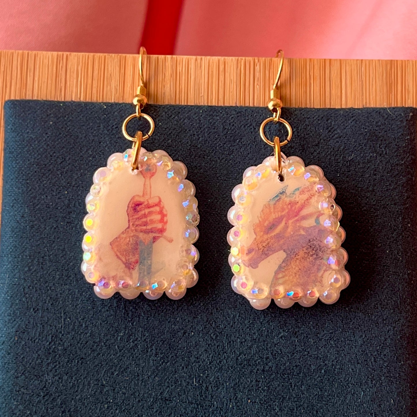 Handcrafted polymer‑clay earrings featuring a peace‑making knight and dragon motif, embellished with iridescent pearl beads, rhinestones, and 18k gold‑plated hypoallergenic findings—perfect whimsical, fairy‑core, fantasy jewelry.