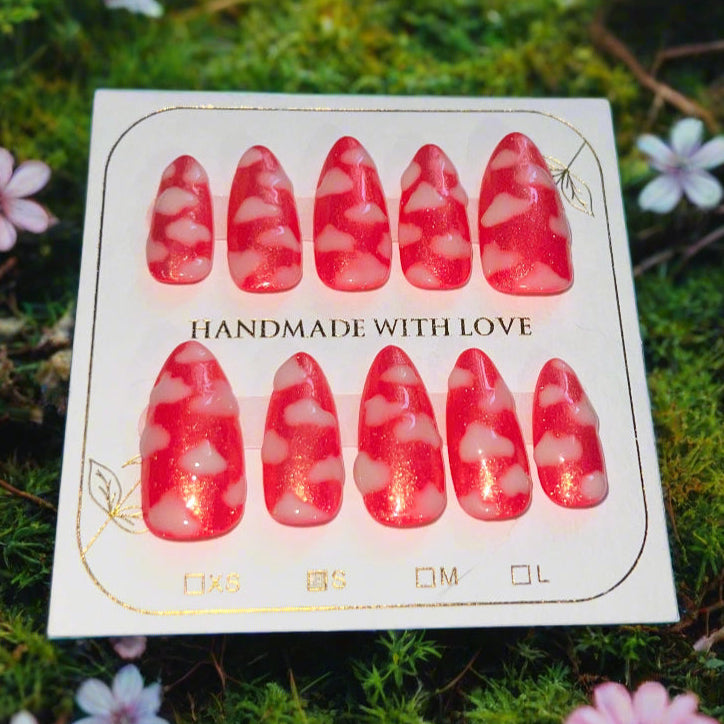 Hot pink nails with a gold shimmer sparkle topped with white fluffy clouds. The pink sky princess nails are on a card which reads "handmade with love"