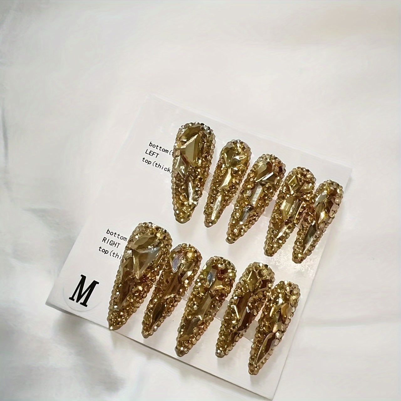 gold rhinestone nail adornment