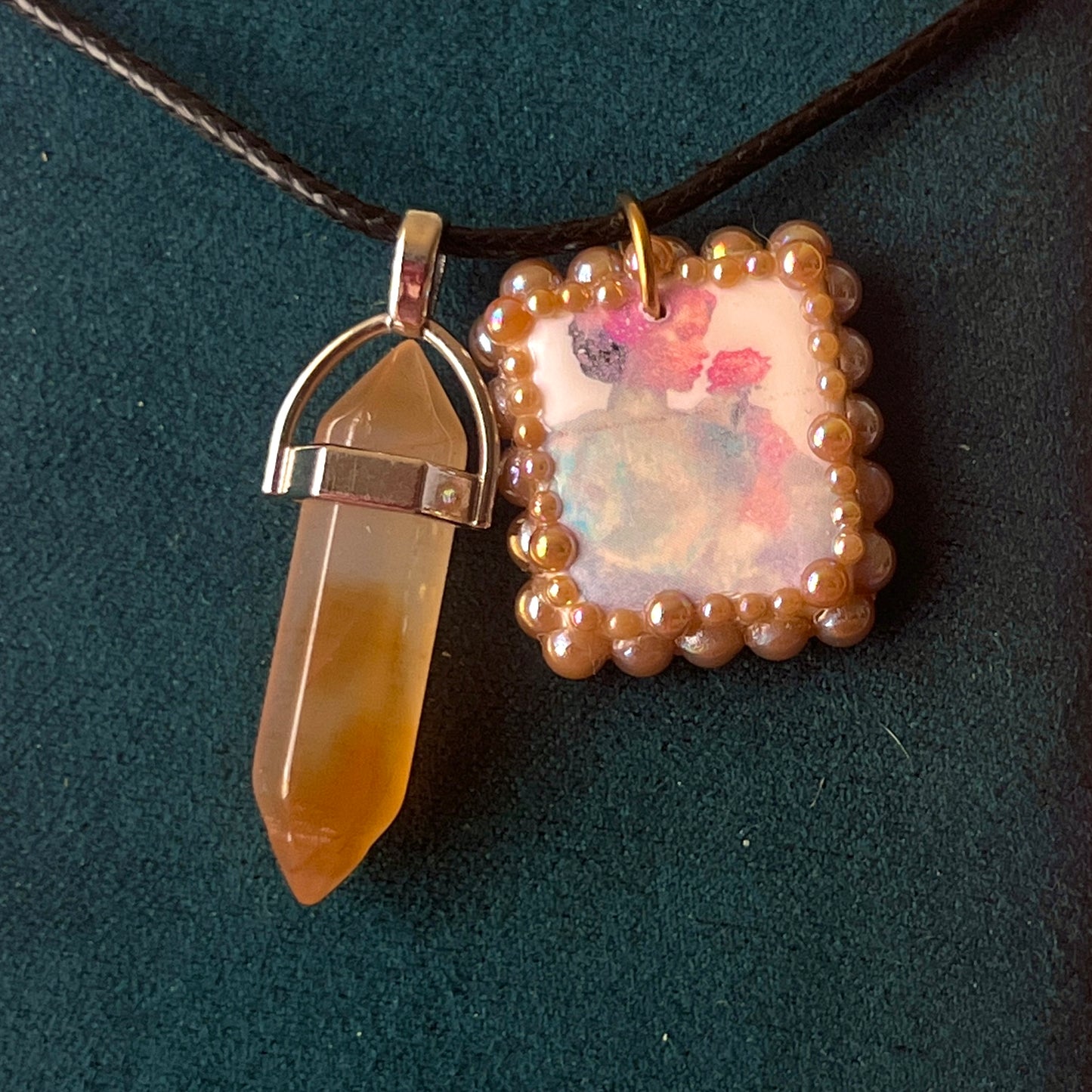Bedazzled iridescent princess necklace — handmade polymer clay Fairy Princess or Flower Princess charm with iridescent glitter backing, bronze-toned pearl bead bedazzling, and gemstone drop pendant on 22" faux leather chain with adjustable extender. Romantic Y2K fairycore coquette statement necklace by Olive Made.