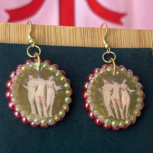 Handmade Three Graces gold earrings: metallic gold‑painted polymer clay framed with iridescent pearls and rhinestones, featuring hypoallergenic 18k gold‑plated hooks—perfect fairy‑core, goddess‑core, statement piece for lovers of Greek mythology jewelry.