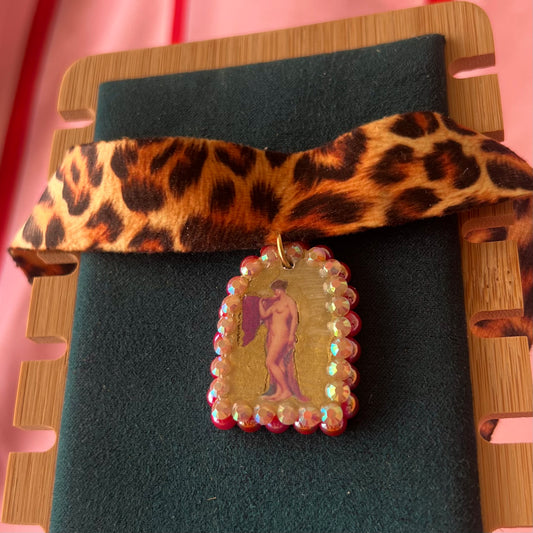 High Jungle Priestess choker — soft cheetah print choker with handmade polymer clay charm featuring neoclassical painting element, framed with bright red pearls. Adjustable fit ~14–16" with extension chain. Gift-ready green Victorian-patterned box + bow. Ready to ship in 1–3 days.