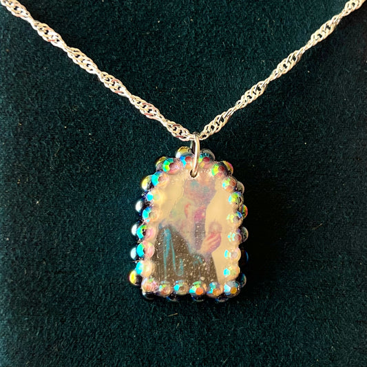Oracle elf necklace — handmade polymer clay medieval-inspired divination elf charm (approx. 1") with iridescent finish, bedazzled with iridescent black pearls + rhinestones on 20" 925 sterling silver chain. Gift-ready Victorian-patterned box with green bow. Ready to ship in 1–3 business days.