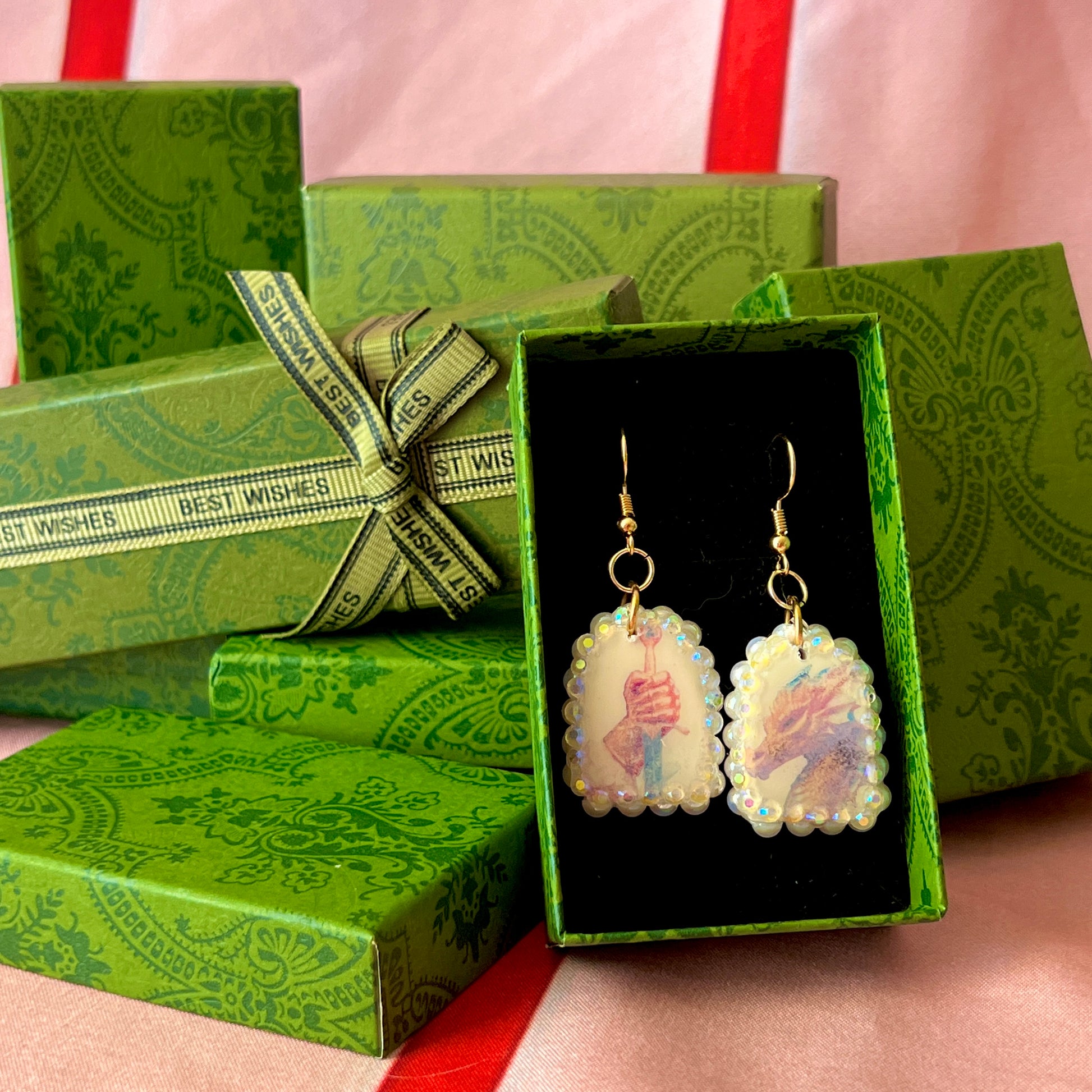 Handcrafted polymer‑clay earrings featuring a peace‑making knight and dragon motif, embellished with iridescent pearl beads, rhinestones, and 18k gold‑plated hypoallergenic findings—perfect whimsical, fairy‑core, fantasy jewelry.