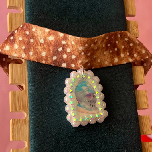 Deer print choker necklace with a handmade polymer clay iridescent medieval knight charm (about 1.75 inches), embellished with white pearls and rhinestones, shown in a Victorian patterned gift box with a green bow.