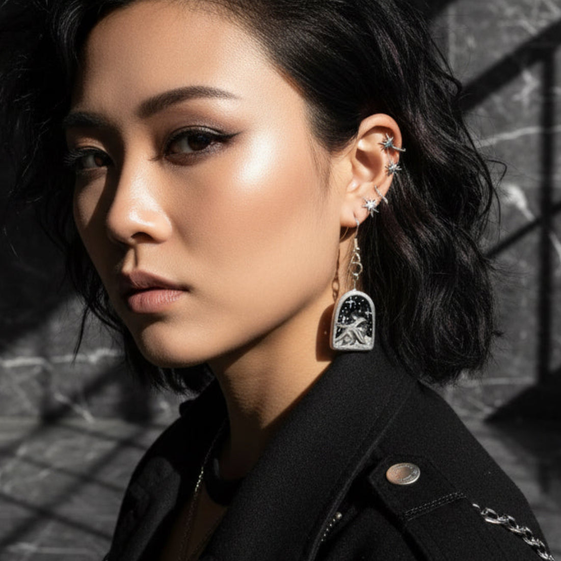 Woman wearing a black jacket with a dark background