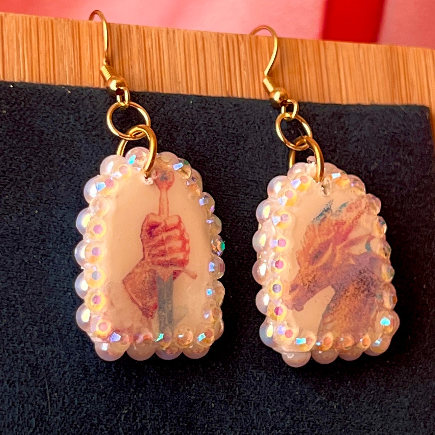 Handcrafted polymer‑clay earrings featuring a peace‑making knight and dragon motif, embellished with iridescent pearl beads, rhinestones, and 18k gold‑plated hypoallergenic findings—perfect whimsical, fairy‑core, fantasy jewelry.
