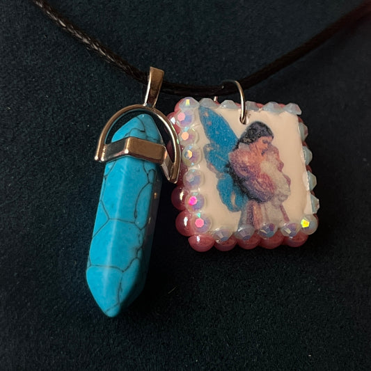 Pink + blue fairy charm necklace — handmade polymer clay fairy pendant framed with iridescent pearls, finished with bright blue gem drop on 22" vegan leather chain with 1.5" extender for adjustable fit. Soft fairycore talisman jewelry. Ready to ship.