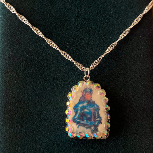 Elf Knight Necklace by Olive Made — a handmade polymer clay fantasy charm necklace featuring a medieval-inspired elf in knight armor, embellished with iridescent pearls and sparkling rhinestones. This whimsical medievalcore / fairycore statement piece comes on a 20” 925 sterling silver chain and arrives gift-ready in a Victorian patterned box with a green bow. Perfect for renaissance fair outfits, elfcore styling, and storybook gifting. Ready to ship in 1–3 business days.