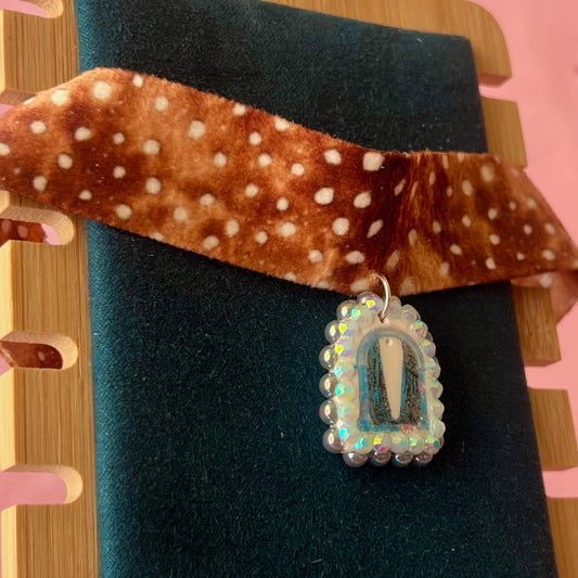 Deer print choker necklace — soft doe/deer print choker (adjustable 13–16") with handmade polymer clay liminal cloaked magic archway charm (approx. 1") bedazzled with iridescent pearls + rhinestones. Gift-ready Victorian-patterned box with green bow. Ready to ship in 1–3 days.