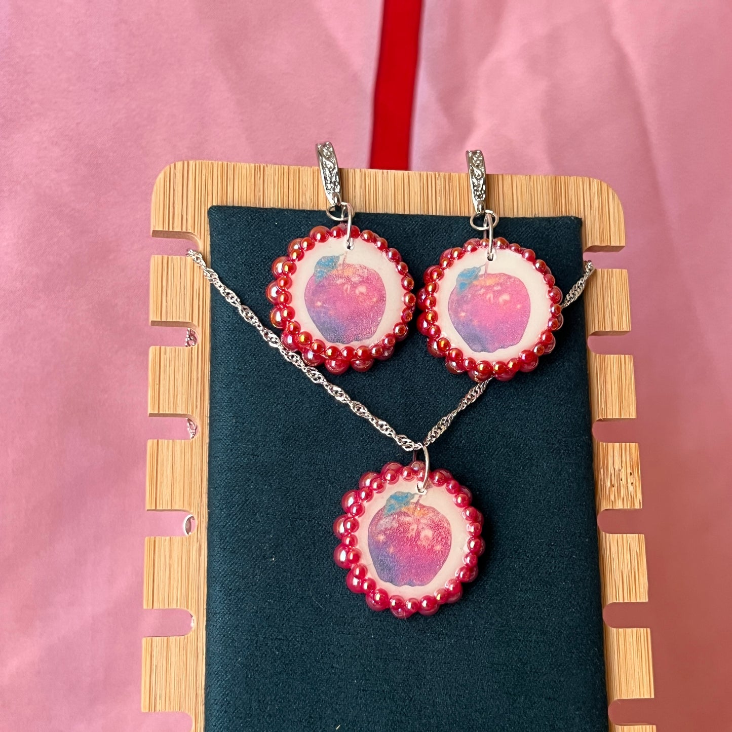 Apple charm earrings & necklace set — handmade polymer clay apple charms bedazzled with iridescent red pearls. Earrings have ornate silver-plated hooks; necklace is on 20" 925 sterling silver chain. Sold separately or as gift set; coquette fruitcore Y2K jewelry. Ready to ship in 1–3 business days.