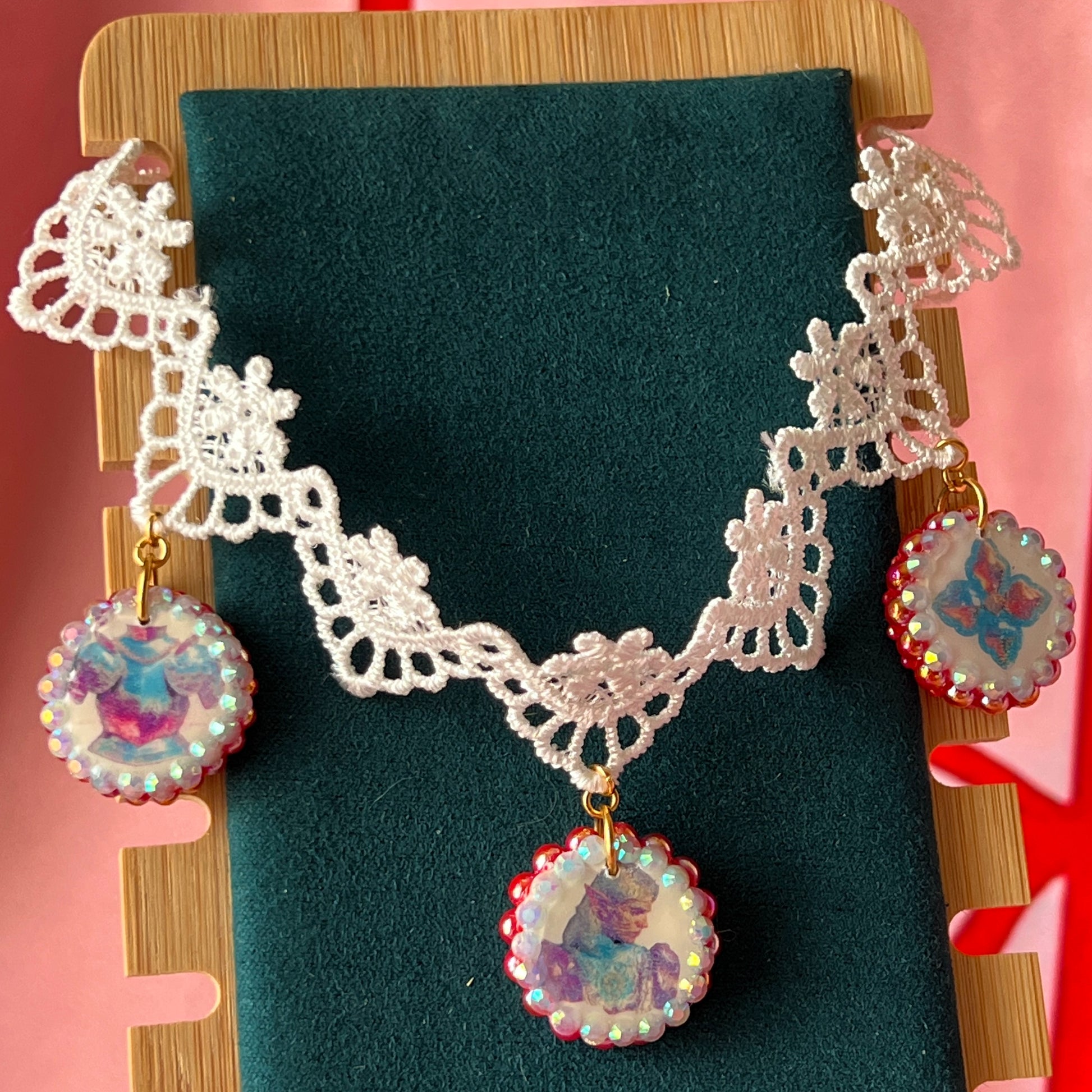 Armored Elf lace choker necklace — handmade polymer clay 3-charm “armored collage” bedazzled with iridescent beads on white lace choker. Gift-ready green Victorian-patterned box. Whimsigoth fairycore coquette cottagecore Y2K choker; ready to ship in 1–3 business days.