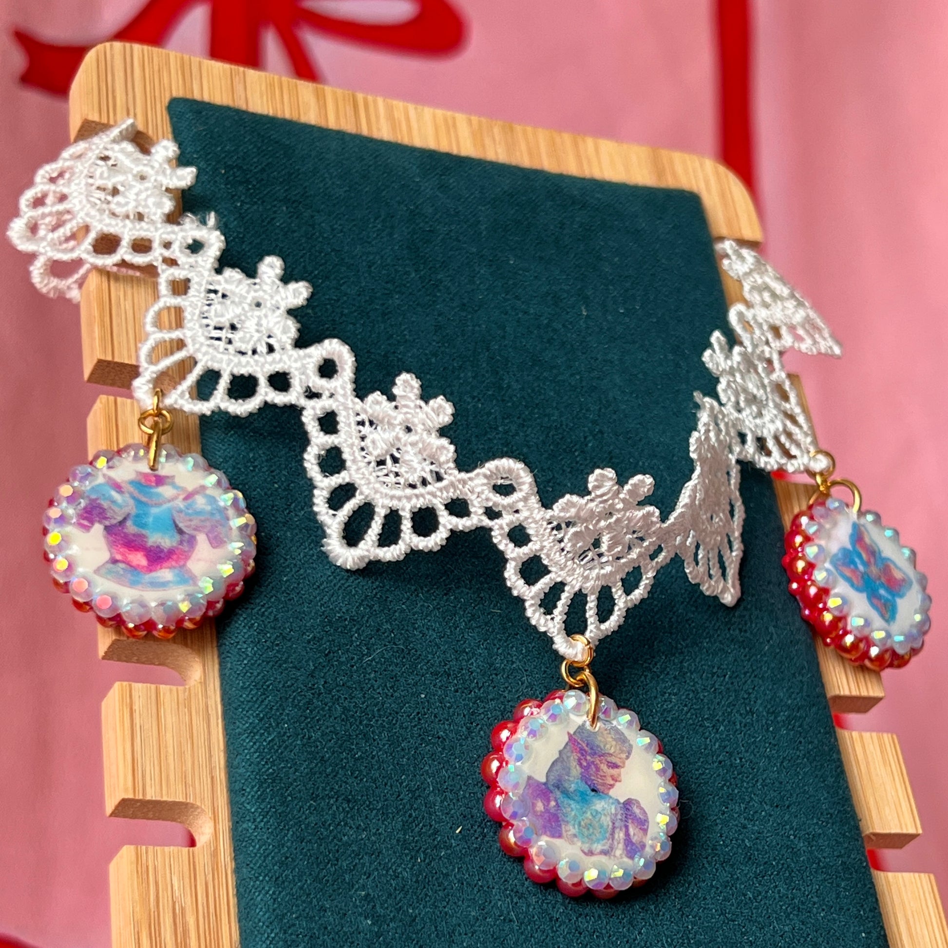 Armored Elf lace choker necklace — handmade polymer clay 3-charm “armored collage” bedazzled with iridescent beads on white lace choker. Gift-ready green Victorian-patterned box. Whimsigoth fairycore coquette cottagecore Y2K choker; ready to ship in 1–3 business days.