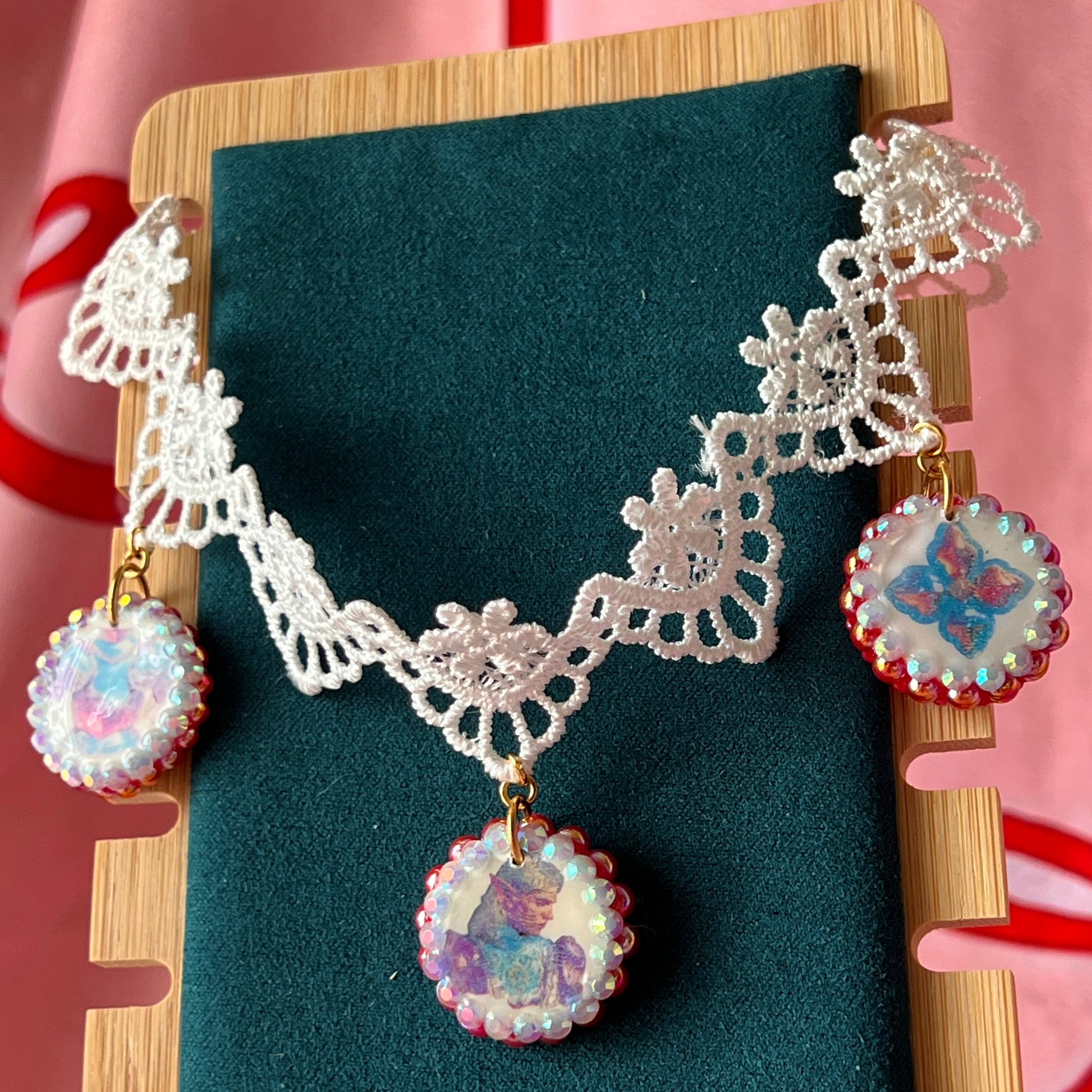Armored Elf lace choker necklace — handmade polymer clay 3-charm “armored collage” bedazzled with iridescent beads on white lace choker. Gift-ready green Victorian-patterned box. Whimsigoth fairycore coquette cottagecore Y2K choker; ready to ship in 1–3 business days.