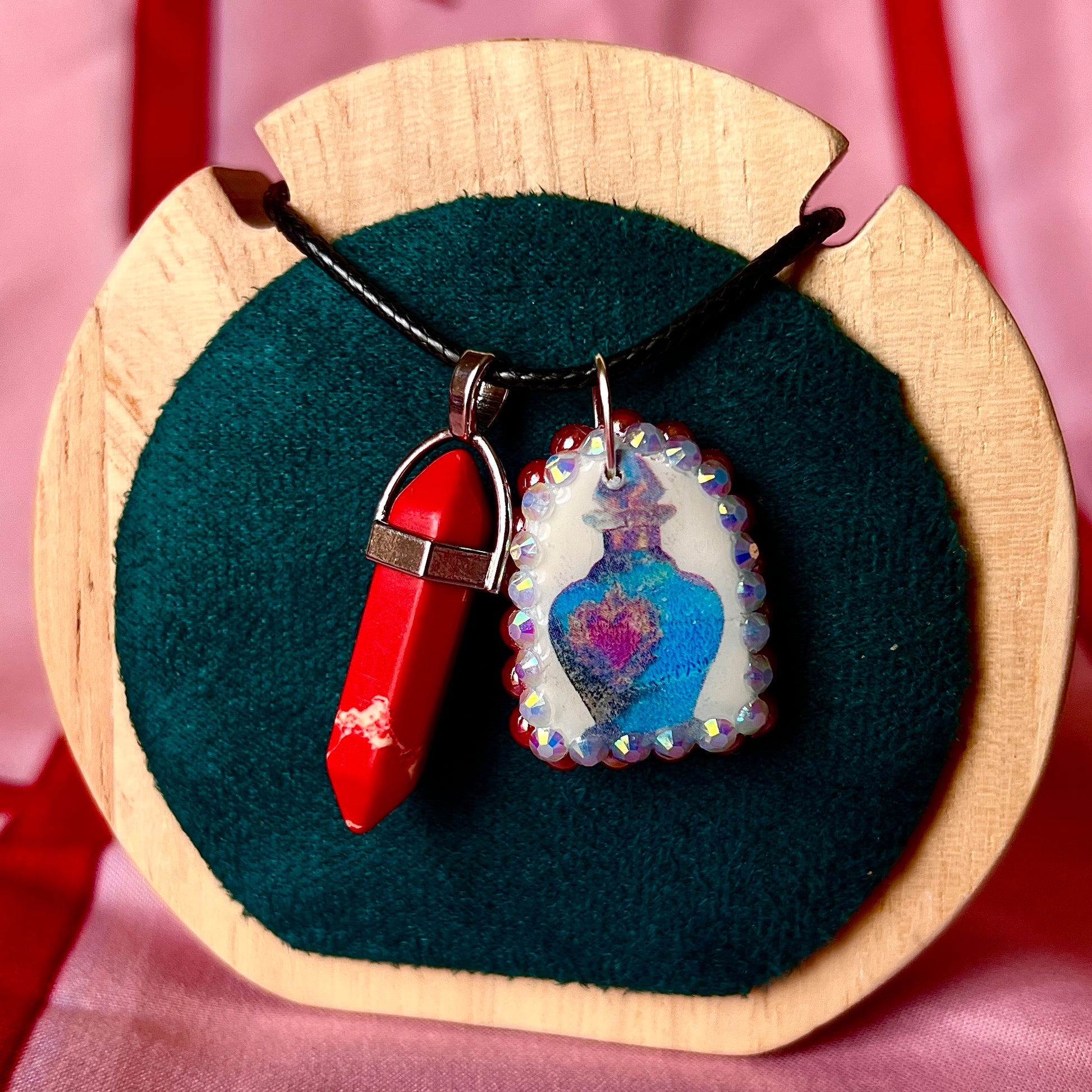 Red crystal blue potion necklace — handmade polymer clay potion bottle pendant hand-bedazzled with iridescent pearls + rhinestones and finished with vivid red crystal accent. Gift-ready Victorian-patterned box. Fairycore Y2K fantasy charm necklace; ready to ship in 1–3 days.