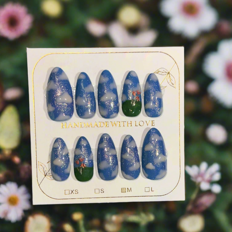 Set of blue and green nail art designs on a card with 'Handmade with Love' text, against a floral background.