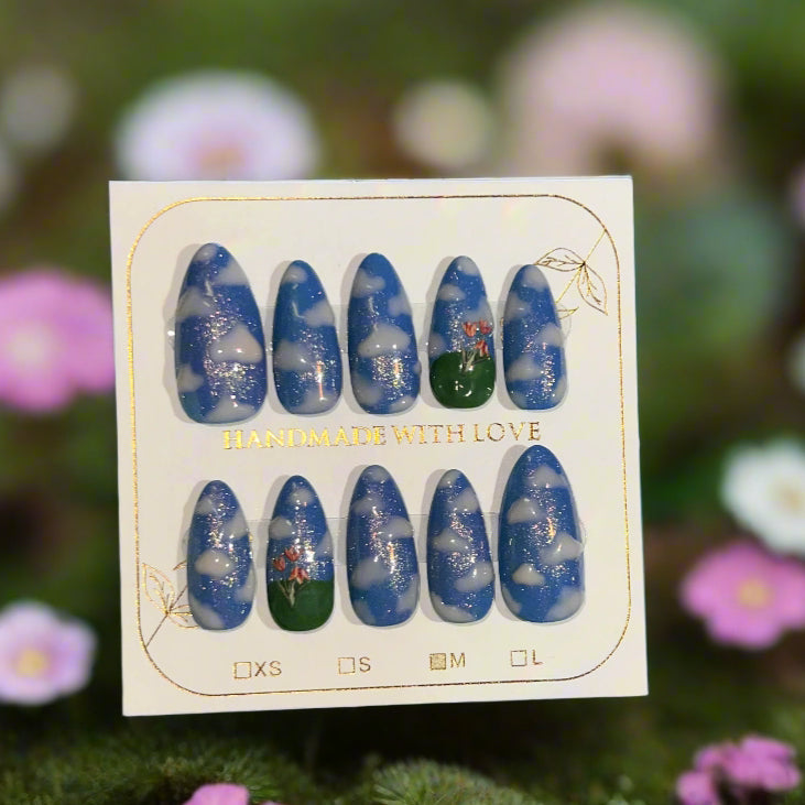 Set of blue and green nail art designs on a card with 'Handmade with Love' text, against a floral background.