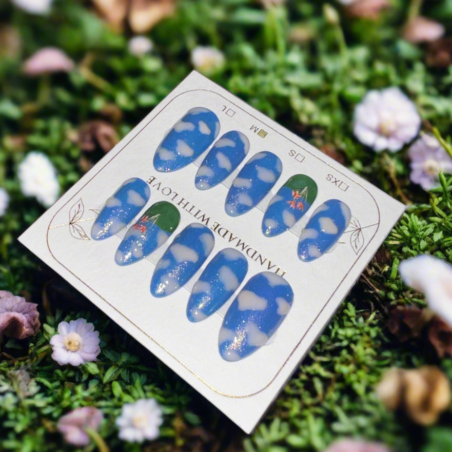 Nail art stickers on a card with a natural background of grass and flowers