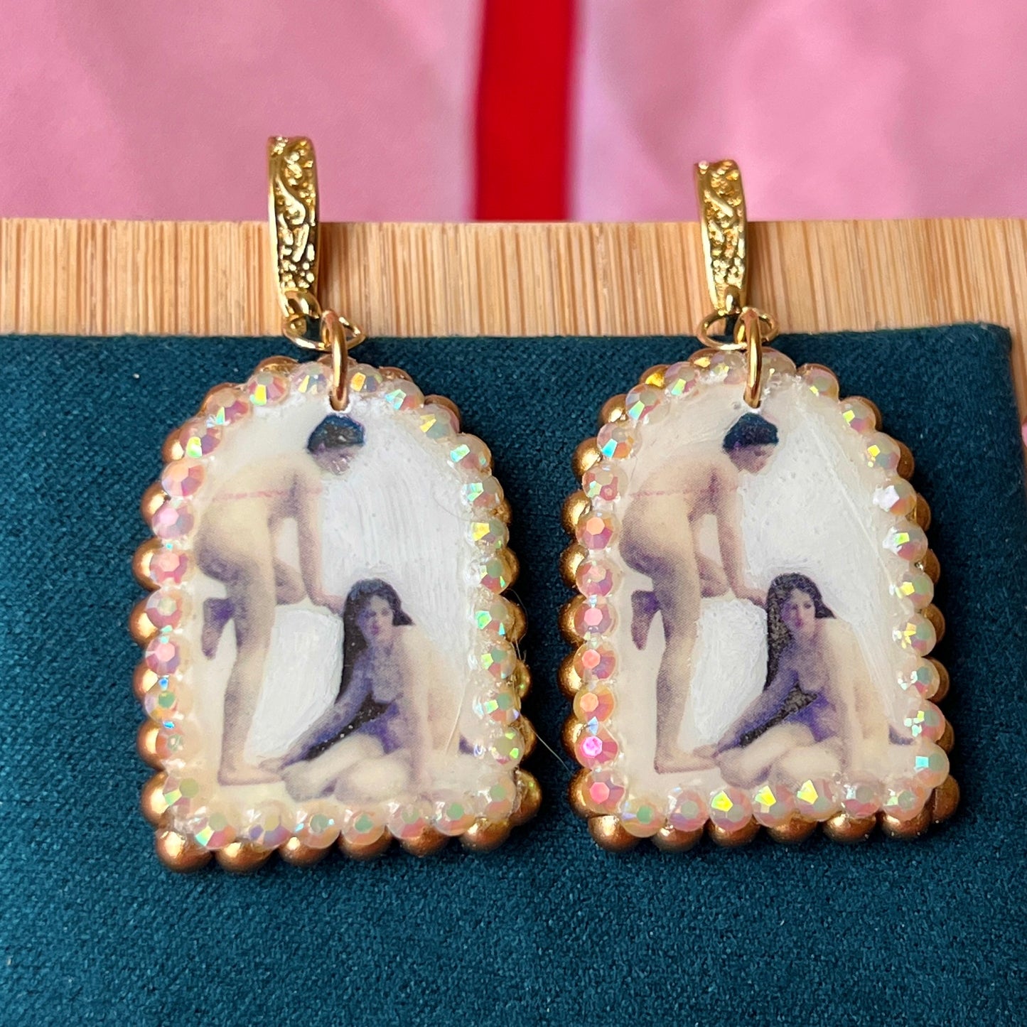 A wearable‑art pair of Bouguereau Bathers earrings — white polymer‑clay arch charms printed with “The Bathers” artwork, embellished with gold pearls and clear rhinestones, on 18k gold‑plated hooks; perfect museum‑core, renaissance‑core, coquette statement earrings for art lovers.