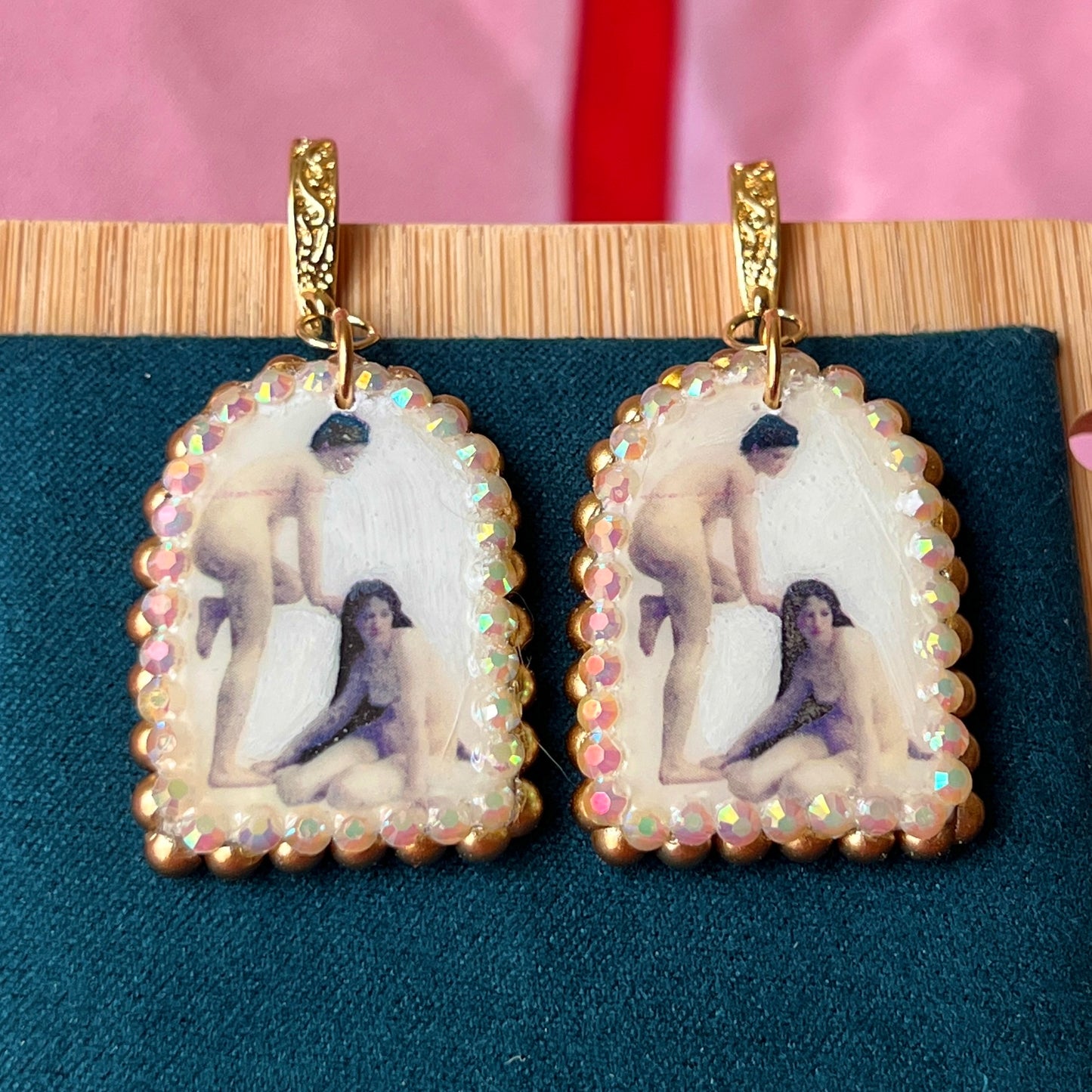 A wearable‑art pair of Bouguereau Bathers earrings — white polymer‑clay arch charms printed with “The Bathers” artwork, embellished with gold pearls and clear rhinestones, on 18k gold‑plated hooks; perfect museum‑core, renaissance‑core, coquette statement earrings for art lovers.