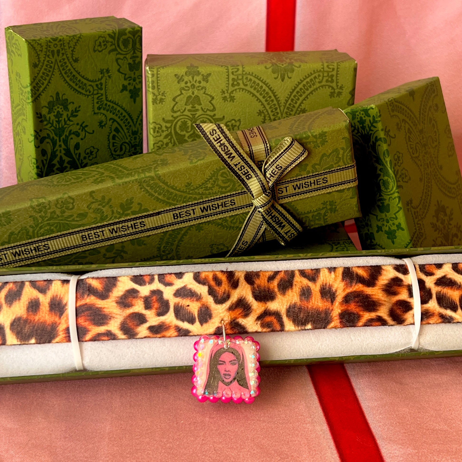 Cheetah print choker necklace — 16" soft fabric cheetah print choker with neon hot pink Y2K nun charm handmade in polymer clay and bedazzled with iridescent beads. Gift-ready green Victorian-patterned box. Whimsigoth grunge indie statement choker; ready to ship in 1–3 business days.