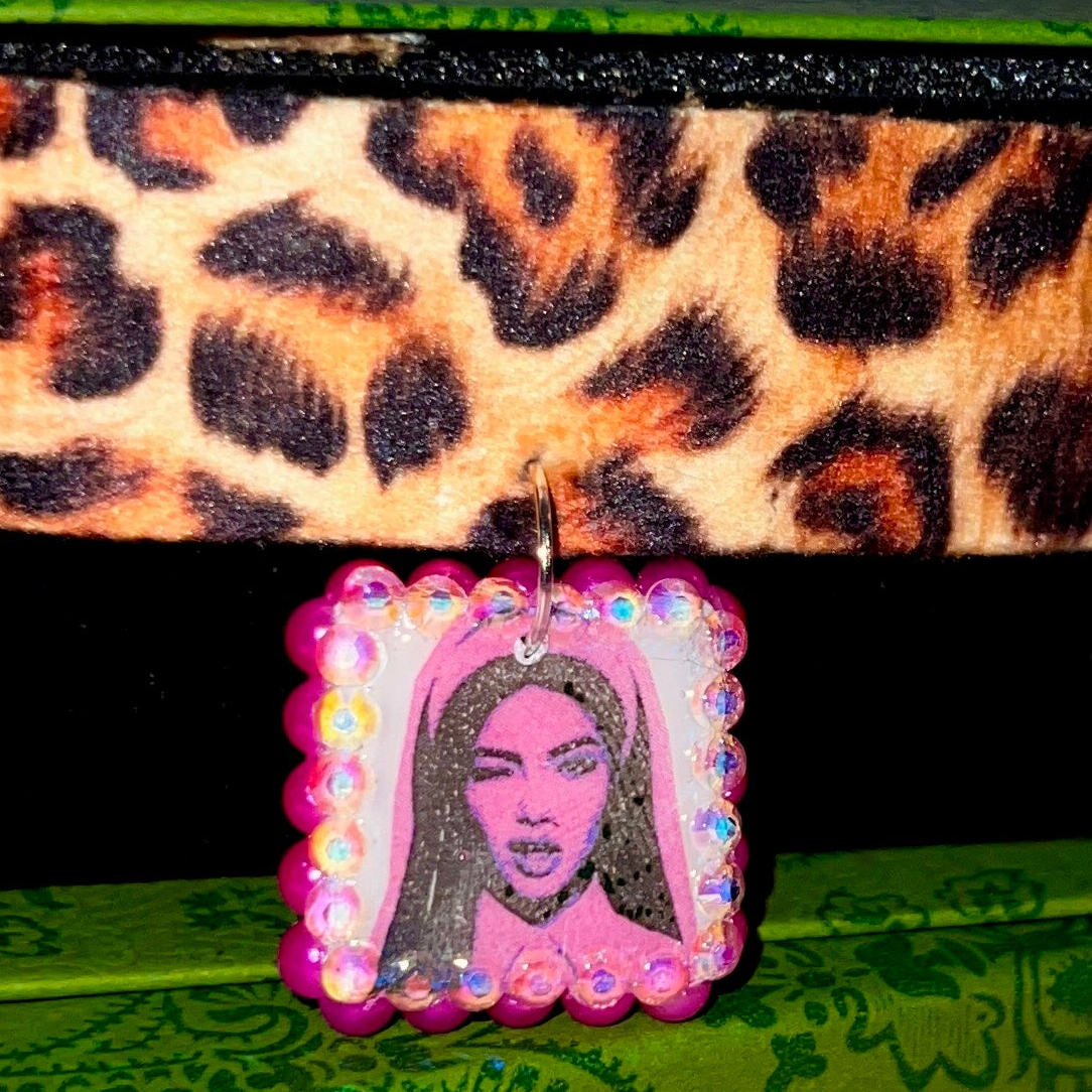 Cheetah print choker necklace — 16" soft fabric cheetah print choker with neon hot pink Y2K nun charm handmade in polymer clay and bedazzled with iridescent beads. Gift-ready green Victorian-patterned box. Whimsigoth grunge indie statement choker; ready to ship in 1–3 business days.