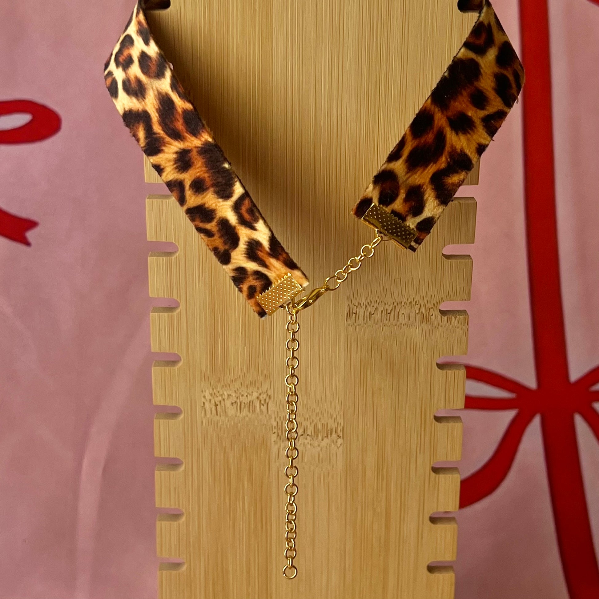Cheetah print TV charm choker — soft cheetah print choker with handmade polymer clay retro Y2K television charm framed by bright orange pearls. Adjustable fit ~14–16" with extension chain. Gift-ready green Victorian-patterned box + bow. Wearable nostalgia kitsch jewelry; ready to ship in 1–3 days.