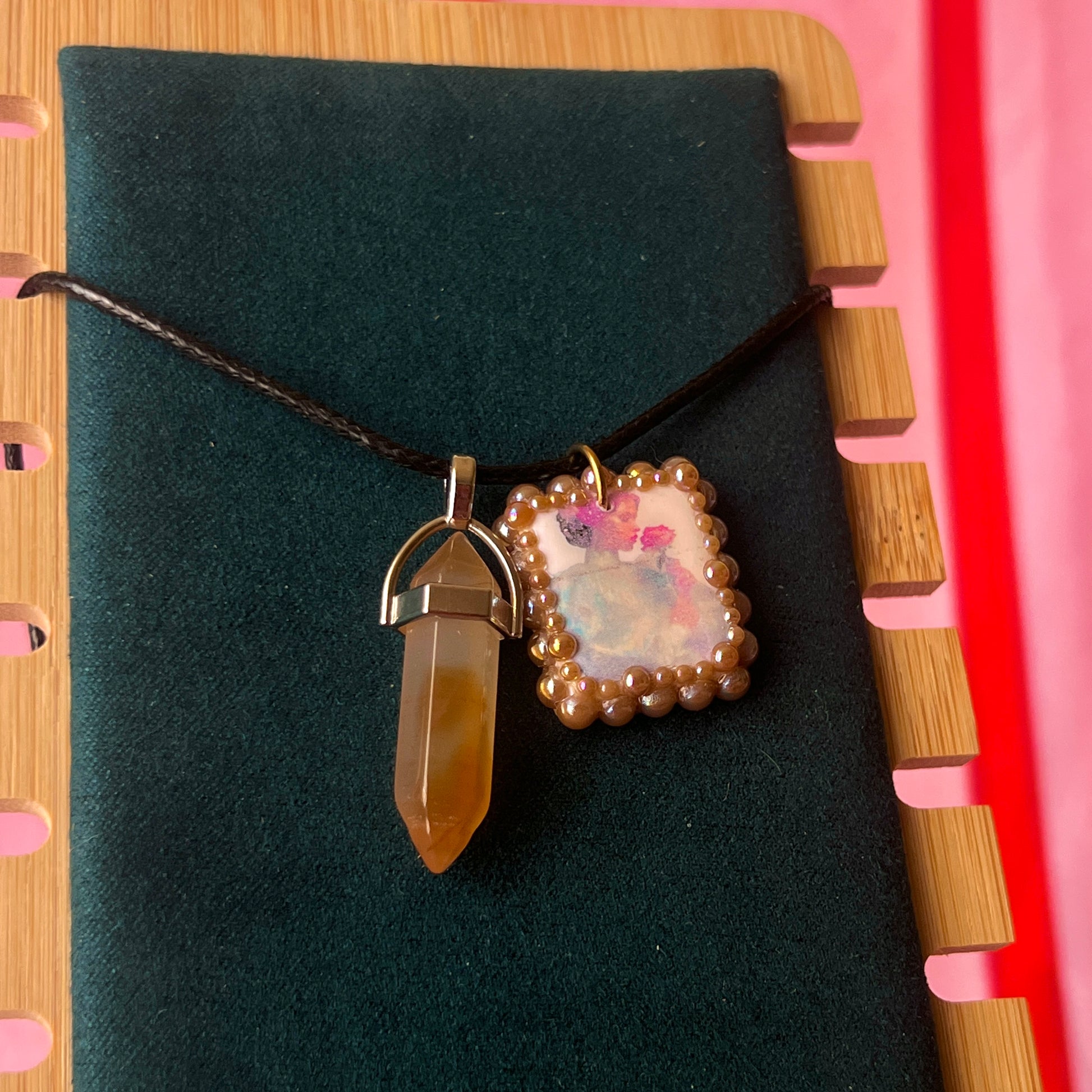 Bedazzled iridescent princess necklace — handmade polymer clay Fairy Princess or Flower Princess charm with iridescent glitter backing, bronze-toned pearl bead bedazzling, and gemstone drop pendant on 22" faux leather chain with adjustable extender. Romantic Y2K fairycore coquette statement necklace by Olive Made.