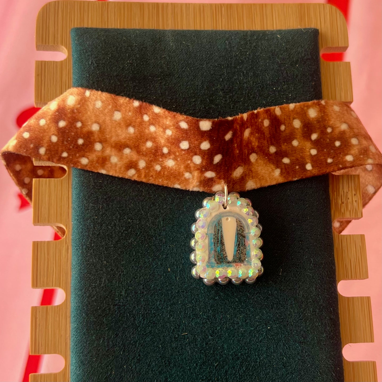 Deer print choker necklace — soft doe/deer print choker (adjustable 13–16") with handmade polymer clay liminal cloaked magic archway charm (approx. 1") bedazzled with iridescent pearls + rhinestones. Gift-ready Victorian-patterned box with green bow. Ready to ship in 1–3 days.