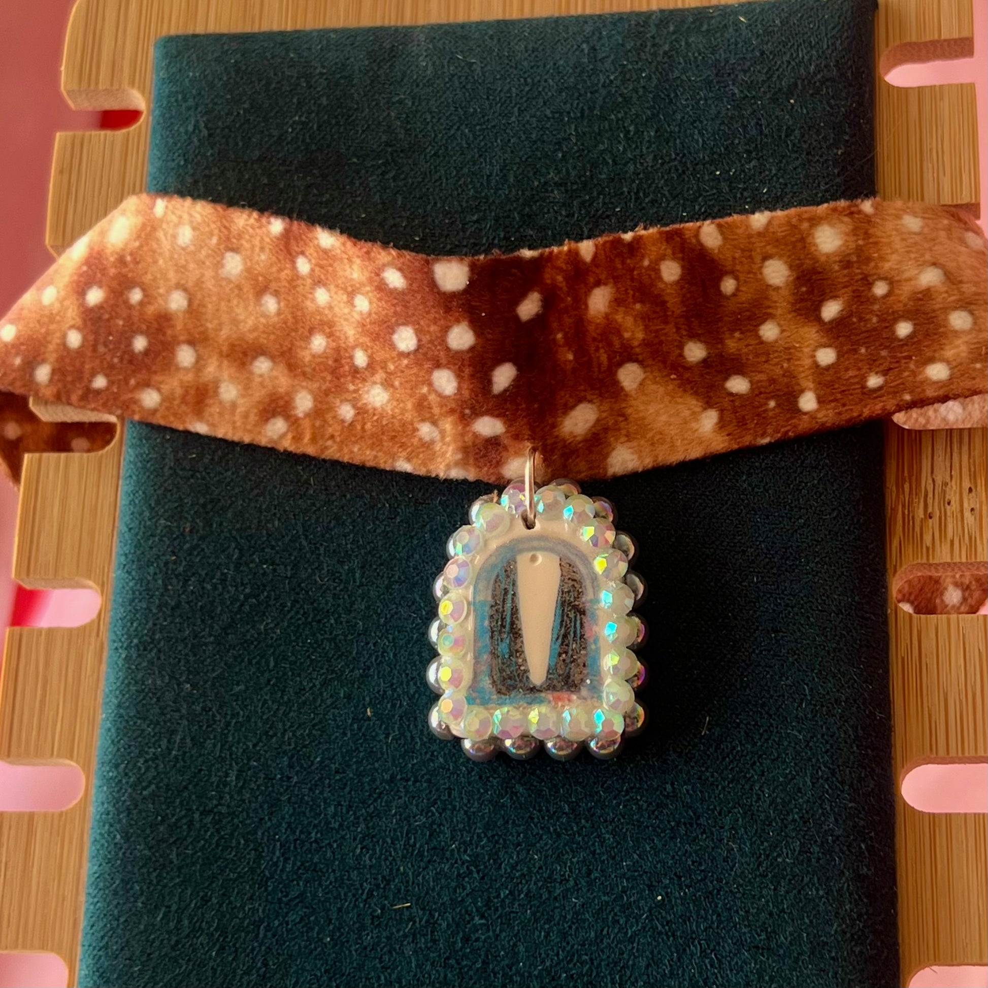 Deer print choker necklace — soft doe/deer print choker (adjustable 13–16") with handmade polymer clay liminal cloaked magic archway charm (approx. 1") bedazzled with iridescent pearls + rhinestones. Gift-ready Victorian-patterned box with green bow. Ready to ship in 1–3 days.