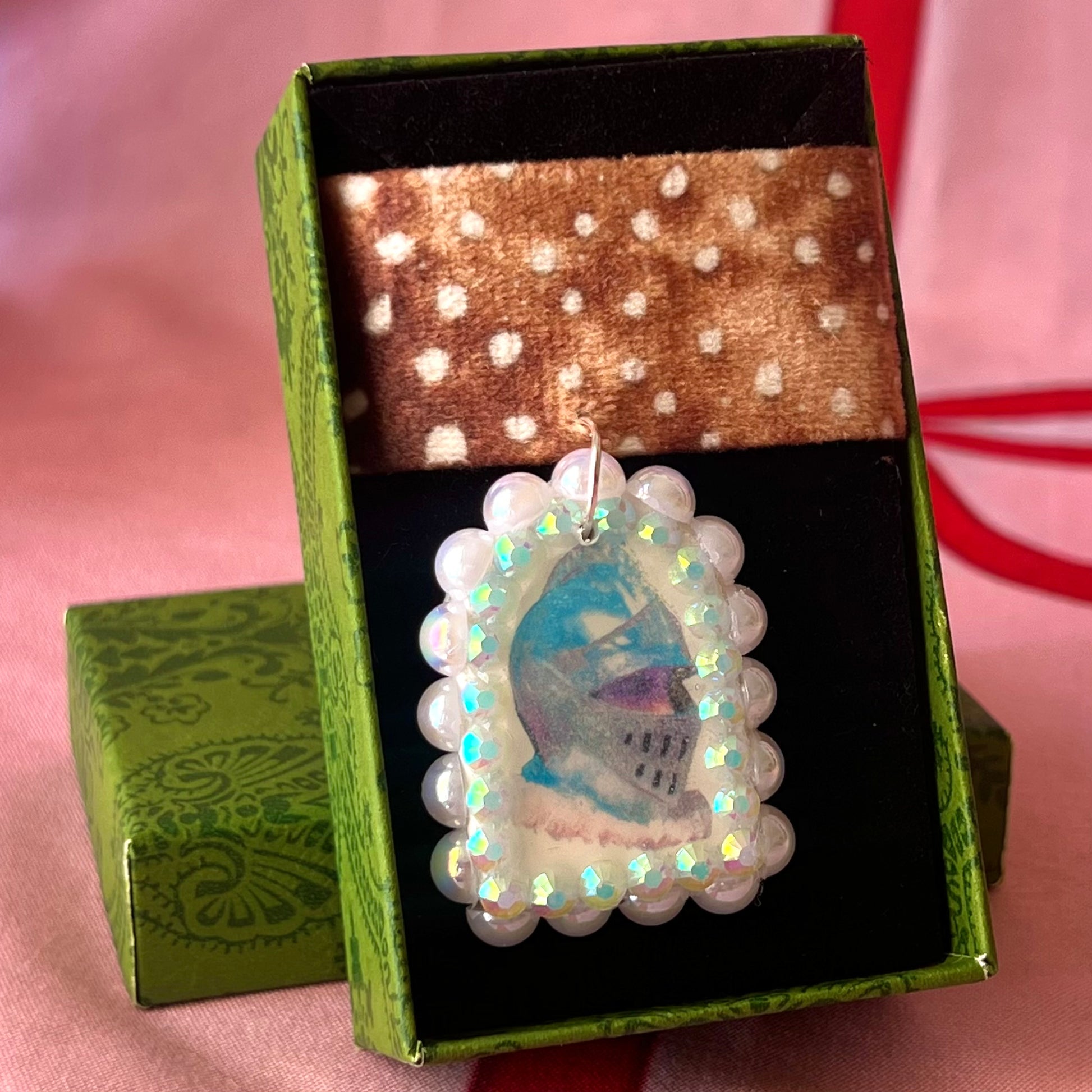 Deer print choker necklace with a handmade polymer clay iridescent medieval knight charm (about 1.75 inches), embellished with white pearls and rhinestones, shown in a Victorian patterned gift box with a green bow.
