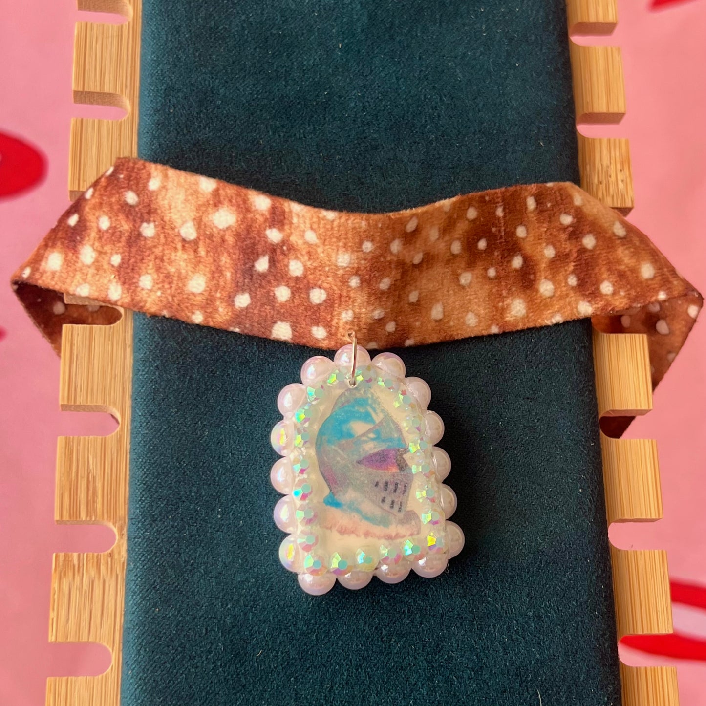 Deer print choker necklace with a handmade polymer clay iridescent medieval knight charm (about 1.75 inches), embellished with white pearls and rhinestones, shown in a Victorian patterned gift box with a green bow.