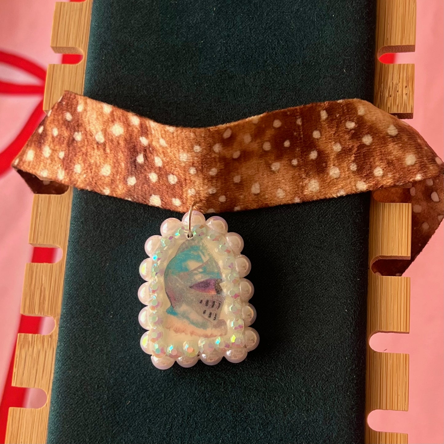 Deer print choker necklace with a handmade polymer clay iridescent medieval knight charm (about 1.75 inches), embellished with white pearls and rhinestones, shown in a Victorian patterned gift box with a green bow.