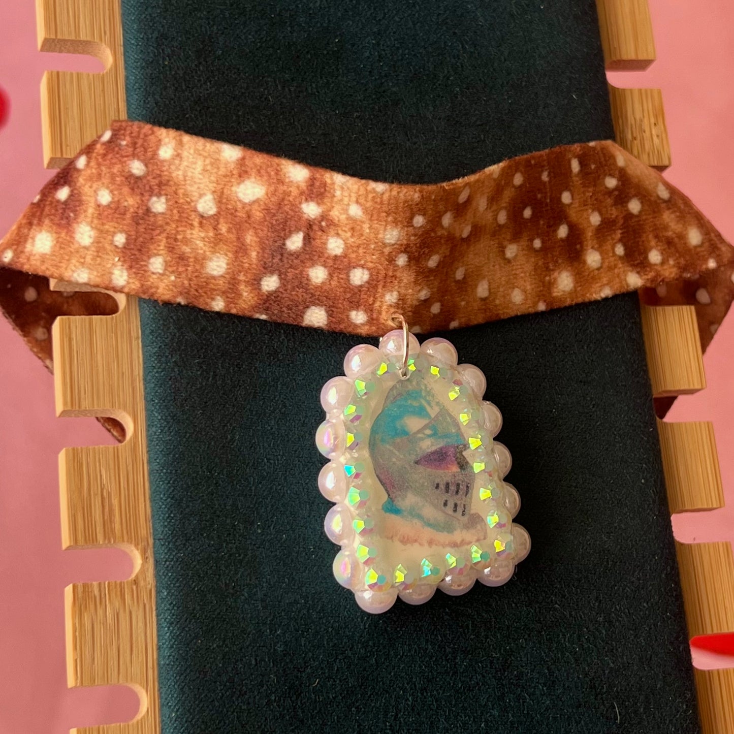 Deer print choker necklace with a handmade polymer clay iridescent medieval knight charm (about 1.75 inches), embellished with white pearls and rhinestones, shown in a Victorian patterned gift box with a green bow.