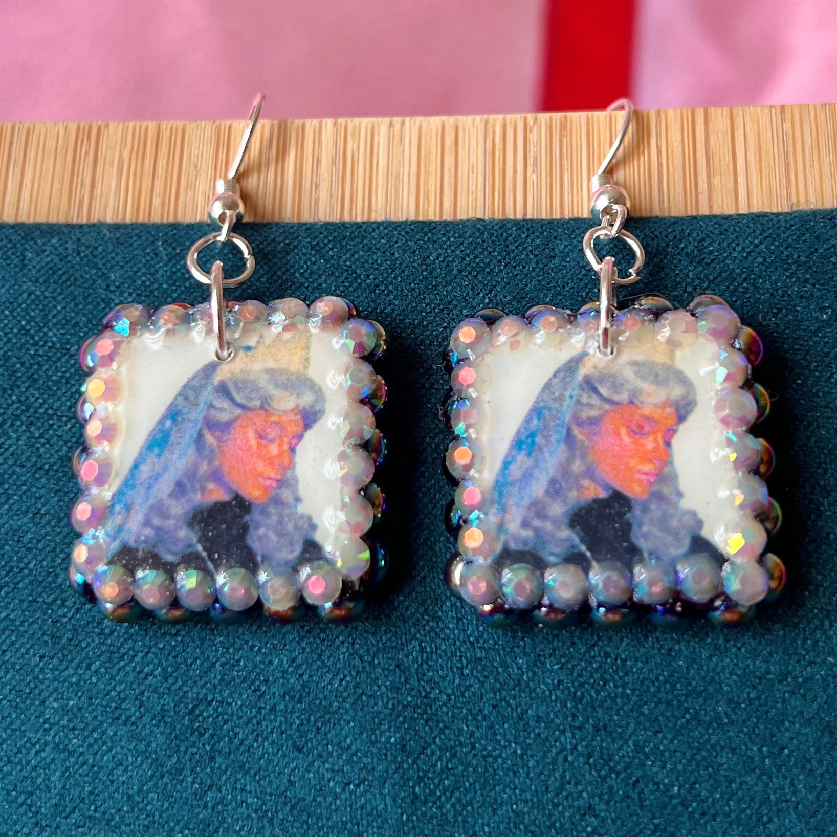 Alt text: Medieval-inspired enchanted princess earrings featuring handmade polymer‑clay character charms—blonde princess with veil or brunette princess with staff—bedazzled with iridescent pearls and rhinestones, set on silver‑plated hypoallergenic hooks; perfect fantasy, princesscore, and cosplay jewelry.
