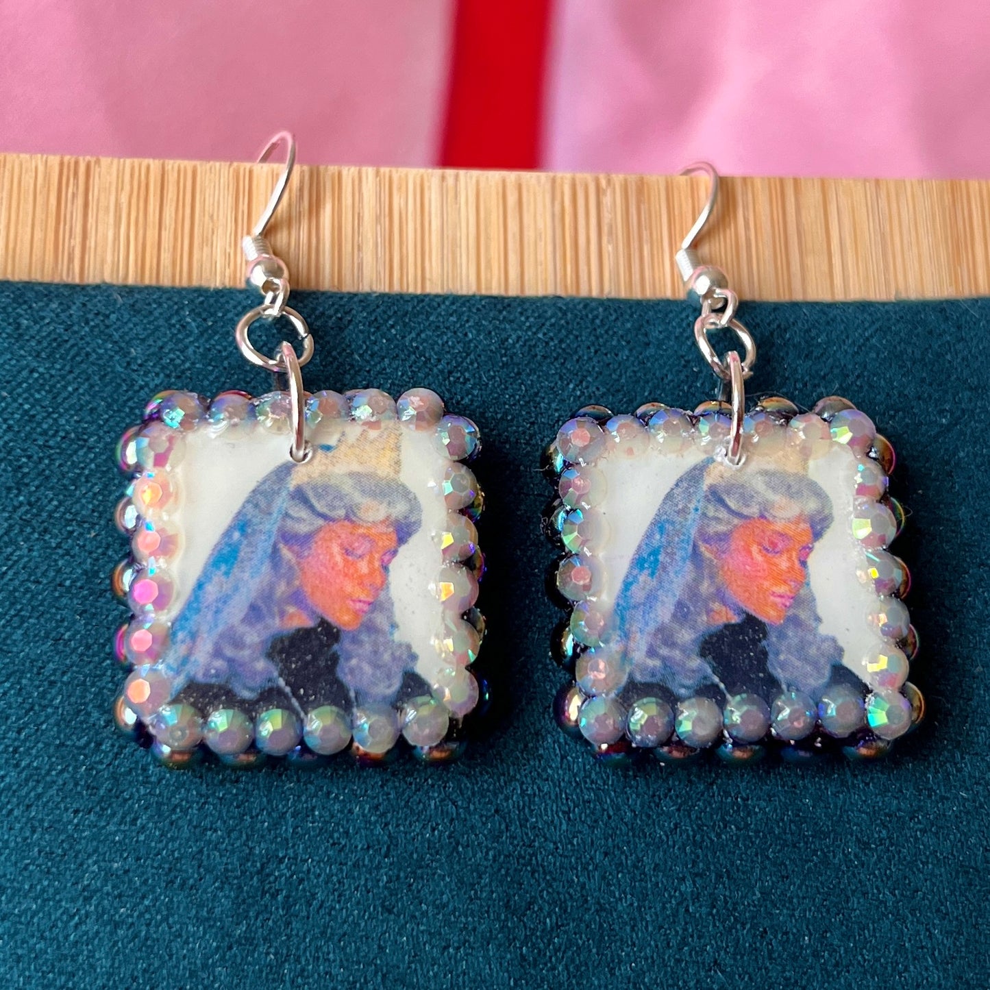 Alt text: Medieval-inspired enchanted princess earrings featuring handmade polymer‑clay character charms—blonde princess with veil or brunette princess with staff—bedazzled with iridescent pearls and rhinestones, set on silver‑plated hypoallergenic hooks; perfect fantasy, princesscore, and cosplay jewelry.