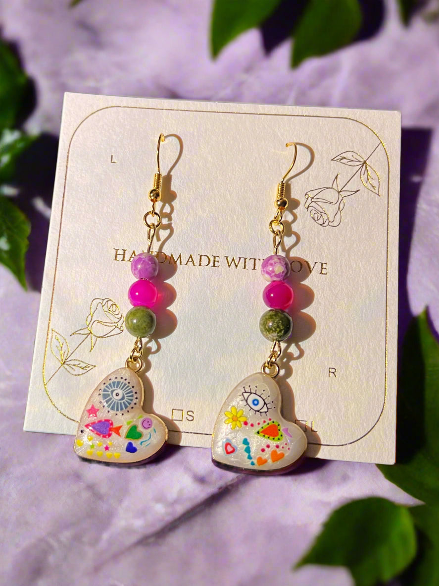 Colorful beaded earrings on a card with 'Handmade with Love' text
