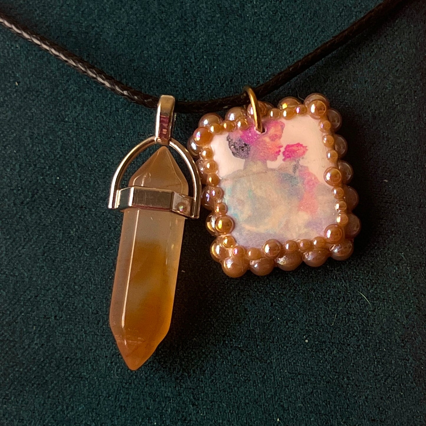 Bedazzled iridescent princess necklace — handmade polymer clay Fairy Princess or Flower Princess charm with iridescent glitter backing, bronze-toned pearl bead bedazzling, and gemstone drop pendant on 22" faux leather chain with adjustable extender. Romantic Y2K fairycore coquette statement necklace by Olive Made.