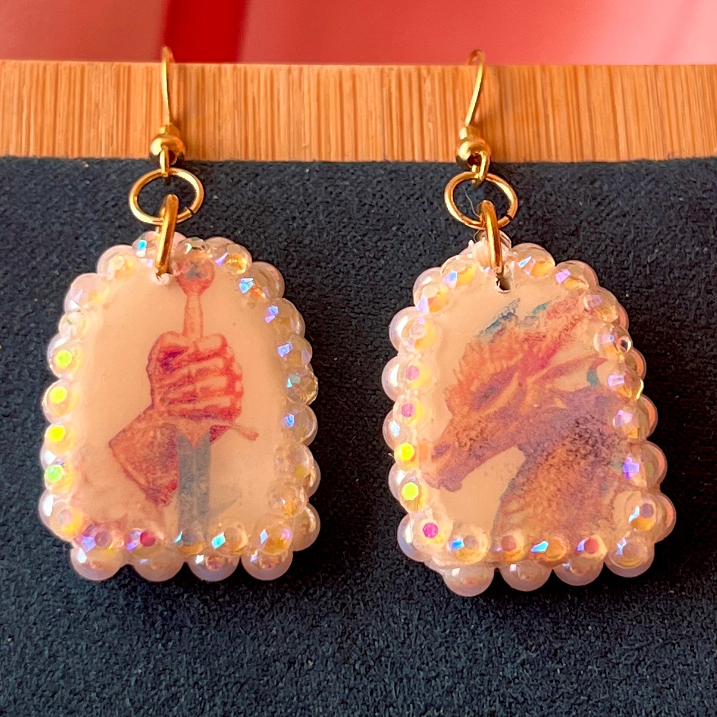 Handcrafted polymer‑clay earrings featuring a peace‑making knight and dragon motif, embellished with iridescent pearl beads, rhinestones, and 18k gold‑plated hypoallergenic findings—perfect whimsical, fairy‑core, fantasy jewelry.