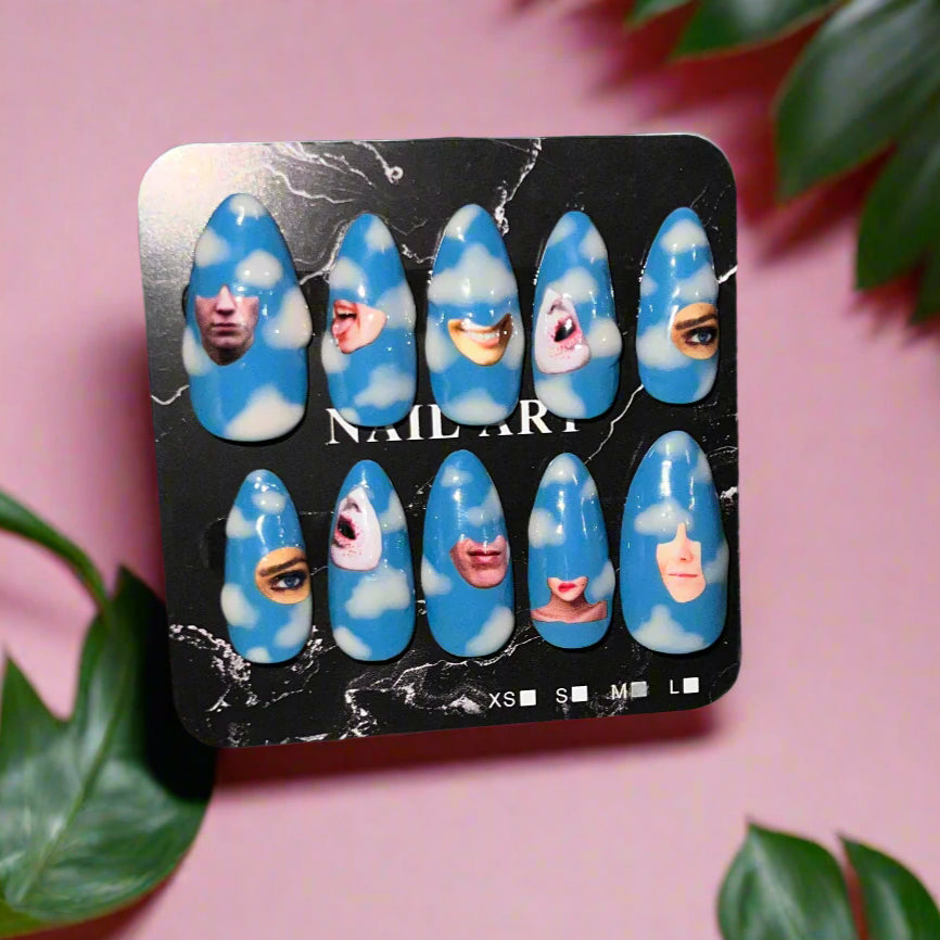 Set of blue nail art designs on a black card with a pink background